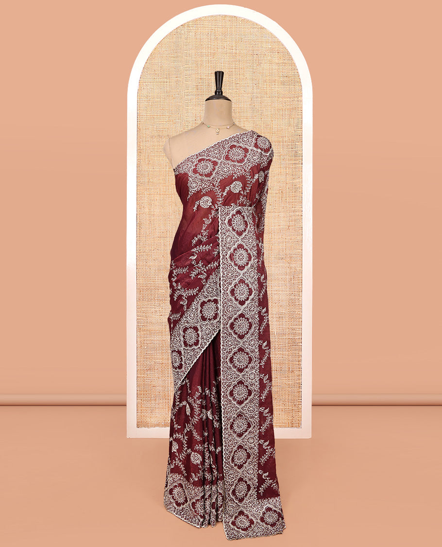 Wine Designer Saree, Decked Up with Floral Embroidered All Over Its Body, a Scallop Embroidered Border, and Matching Blouse