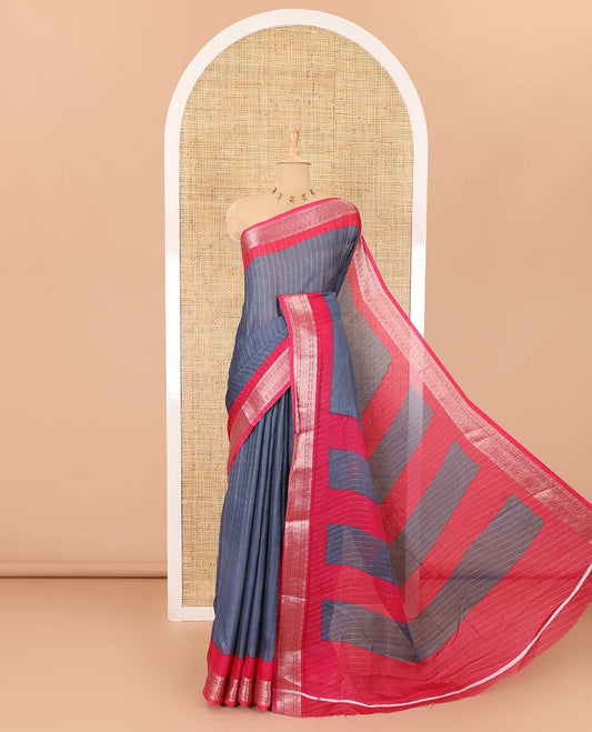 Grey vertically striped moss chiffon saree with contrast traditional zari design borders, striped pallu, and a contrast blouse