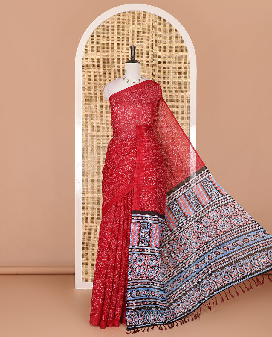 Borderless red bandhani style floral, paisley, and chakra printed semi-jute silk saree, contrast ajrakh printed pallu, and ajrakh printed blouse