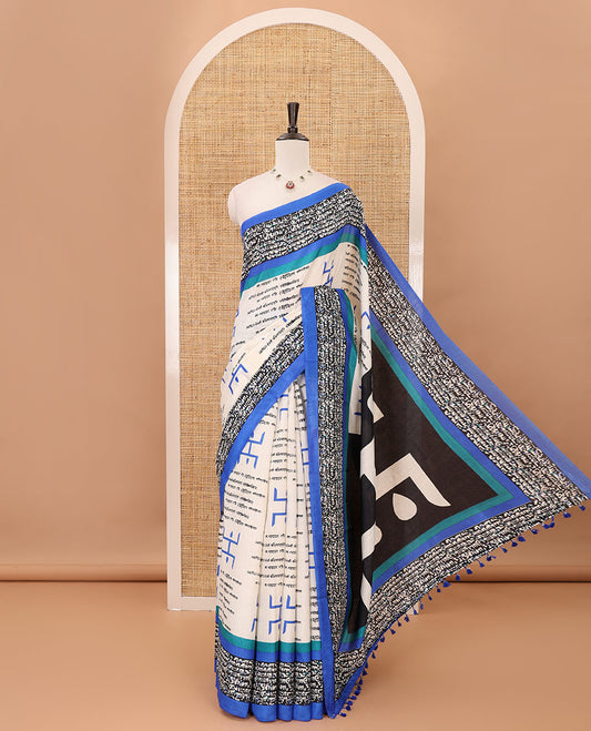 Chikku color swastika & Hindi typography printed jute cotton saree, contrast printed border, printed pallu & plain royal blue blouse