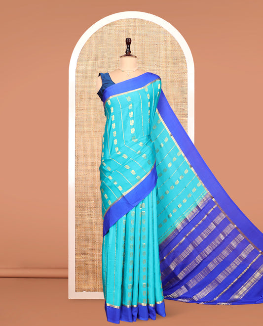 Blue Mysore Silk Saree, Adorned With Zari Stripes and Peacock Buttas Across Its Body, Complemented by Captivating Contrast Border of Traditional Zari Designs, Pallu Steeped with Traditional Zari Designs, and Paired with a Contrast Blouse