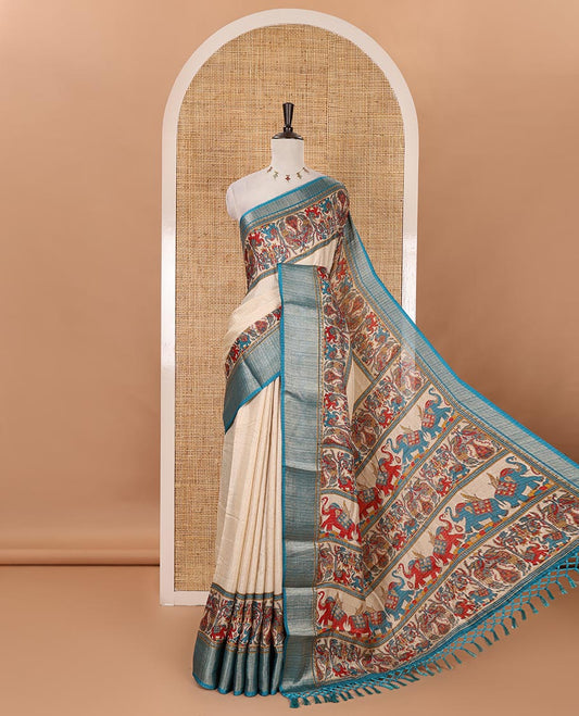 Chikku striped & printed dola silk saree, contrast blue traditional zari border & pallu of elephant & peacock print & contrast printed blouse