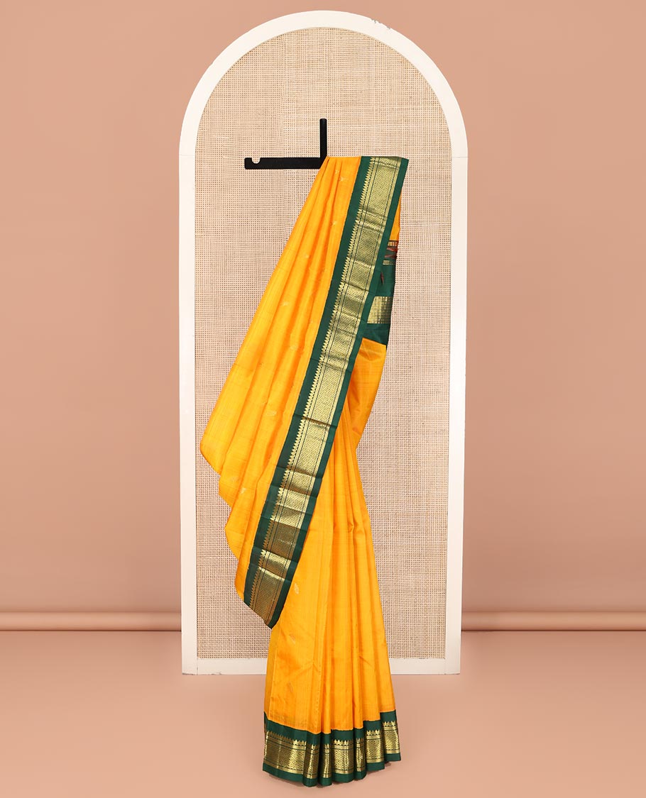 Yellow Kanchipuram Silk Saree, Sparsely Sparkled with Zari Buttas on Its Body, Complemented by a Contrast One-Sided Korvai Border of Thilakam Mokku, Banaras, Muthu, and Kamalam Designs, Pallu Features Zari Designs, and Comes Without a Blouse