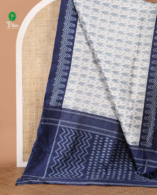 White ikat-style printed Litchi crushed saree, contrast blue ikat border, pallu of ikat chevron & dots & ikat printed blouse