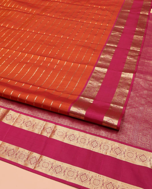 Orange Vasundhara Silk Saree, Richly Detailed with Zari Stripes All Over Its Body, Complemented by Contrast Rettai Pettu Border of  Manga, Muthu, Diamond and Chakram Designs, Intricately Zari Detailed Pallu, and Paired with a Contrast Blouse