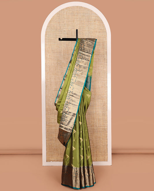 Green zari buttas Vasundhara silk mix saree, contrast border of thilakam mokku, muthu, mayil, laddu kamalam,  and kuyil kann designs, and pallu of paisleys