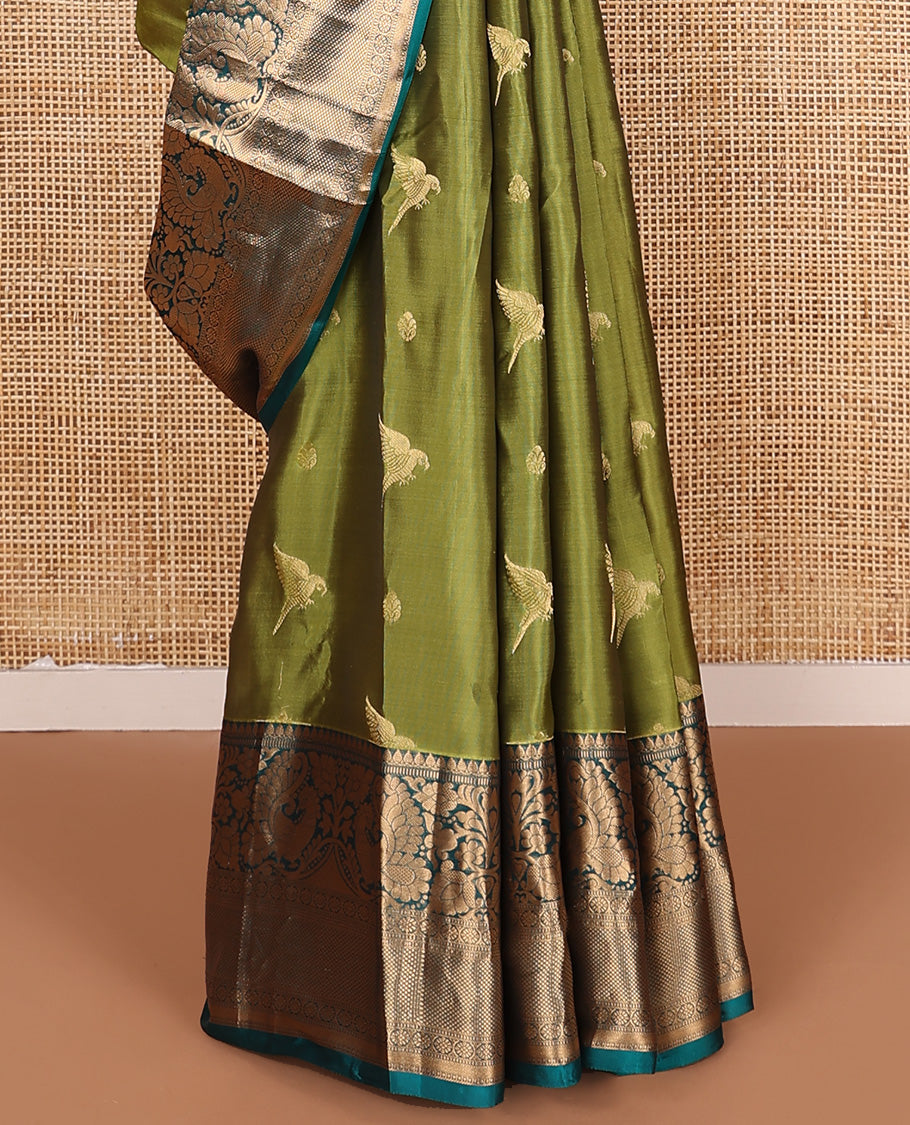 Green zari buttas Vasundhara silk mix saree, contrast border of thilakam mokku, muthu, mayil, laddu kamalam,  and kuyil kann designs, and pallu of paisleys