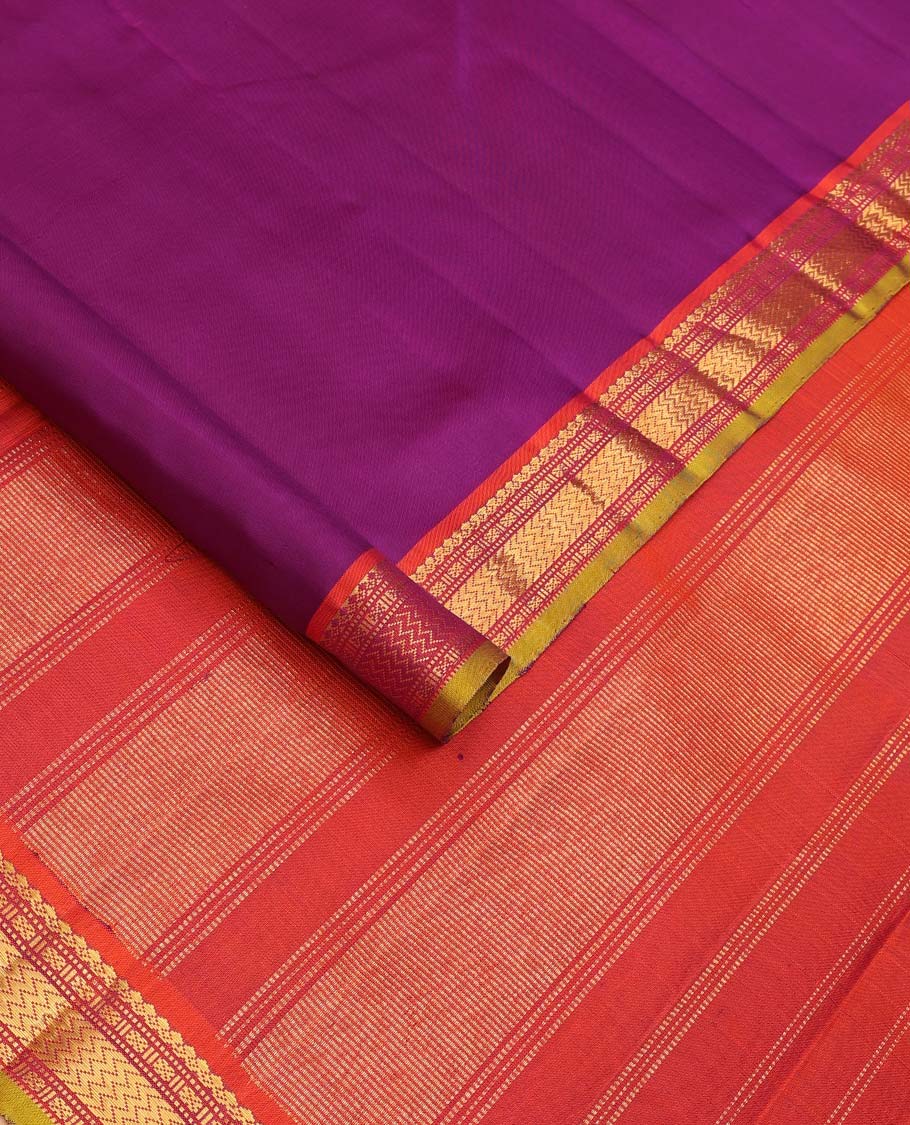 Purple plain Kanchipuram silk saree, contrast border of salngai, muthu, cross kamalam, and vanki designs, and zari design pallu