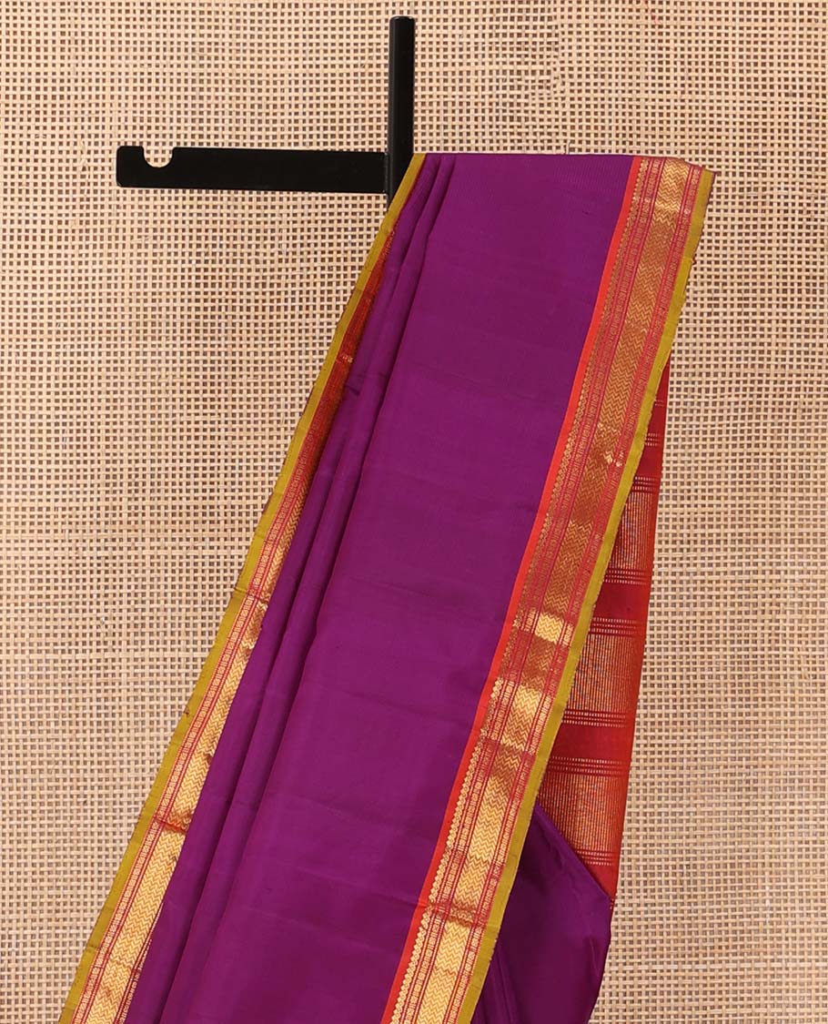 Purple plain Kanchipuram silk saree, contrast border of salngai, muthu, cross kamalam, and vanki designs, and zari design pallu