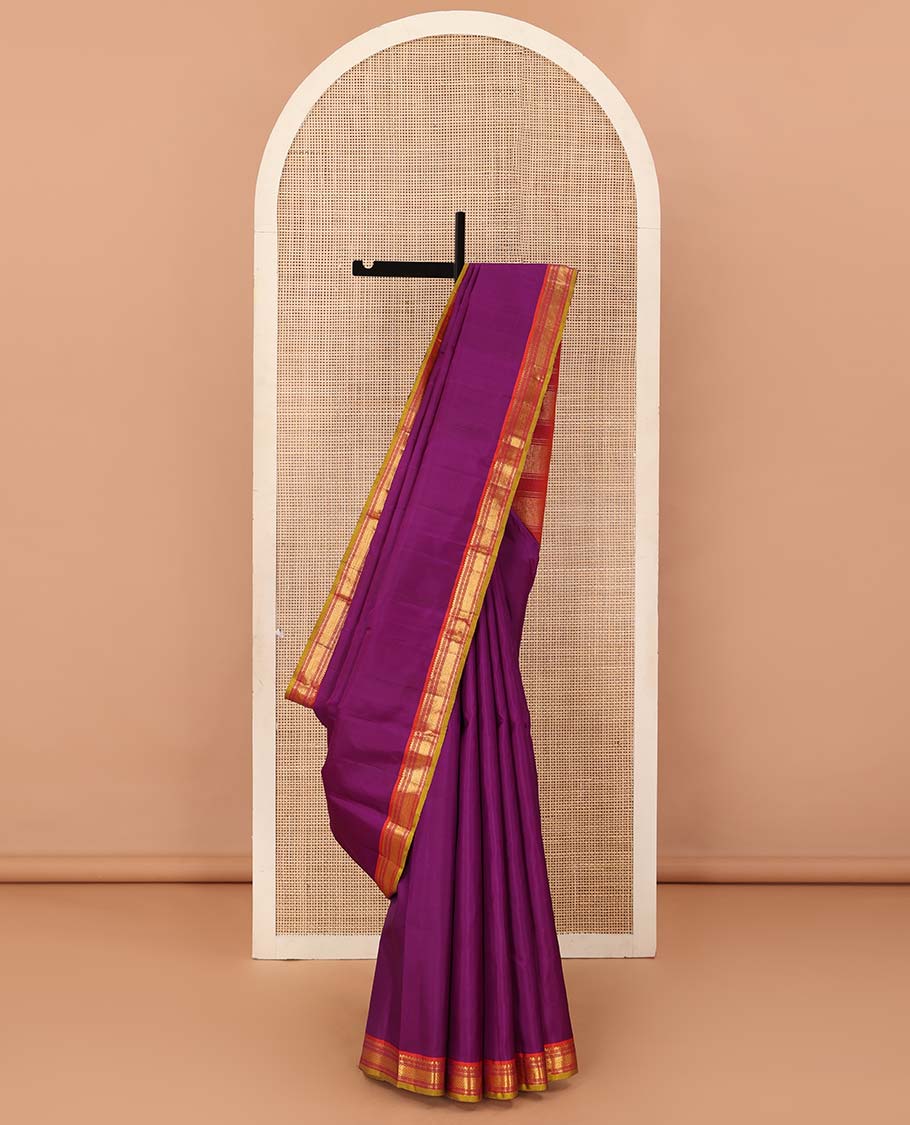 Purple plain Kanchipuram silk saree, contrast border of salngai, muthu, cross kamalam, and vanki designs, and zari design pallu