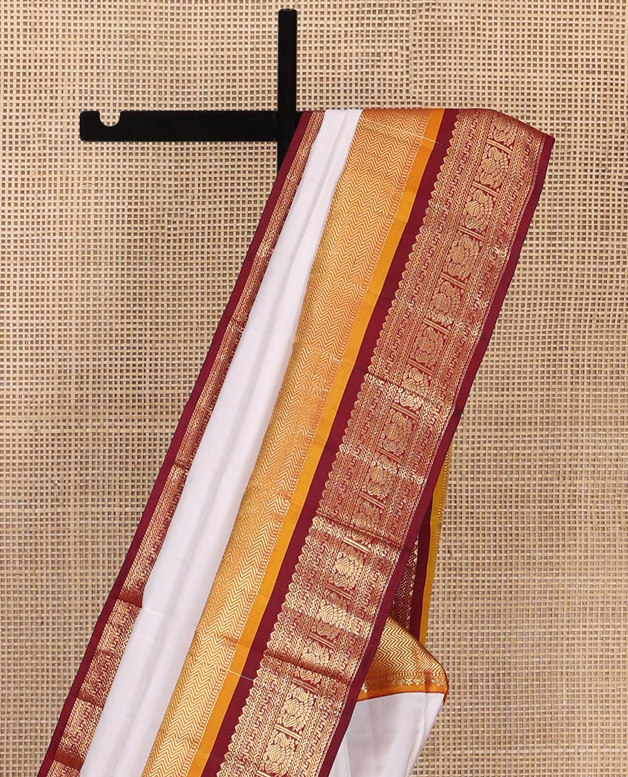 White Plain Vasundhara Silk Saree, Complemented by a Contrast Border of Muthu, Vanki, Rekku, Neli, Greek Key, and Iruthalai Pakshi Designs, Grand Jaal Pallu, and Paired with a Contrast Blouse