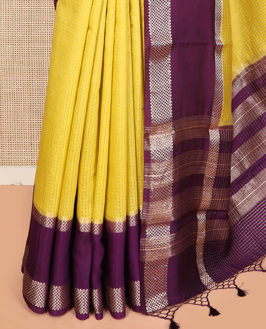 Yellow micro-checked assam silk saree, contrast traditional zari border of floral designs, and zari striped pallu