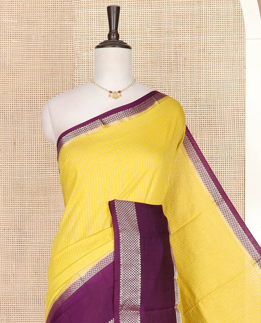 Yellow micro-checked assam silk saree, contrast traditional zari border of floral designs, and zari striped pallu