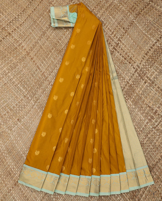 Mustard Budget Silk Saree Adorned with Peacock Chakram Buttas, Complemented with a Contrast Traditional Zari Peacock Chakram Design Border, Pallu of Zari Design Weave, and Paired with a Contrast Blouse