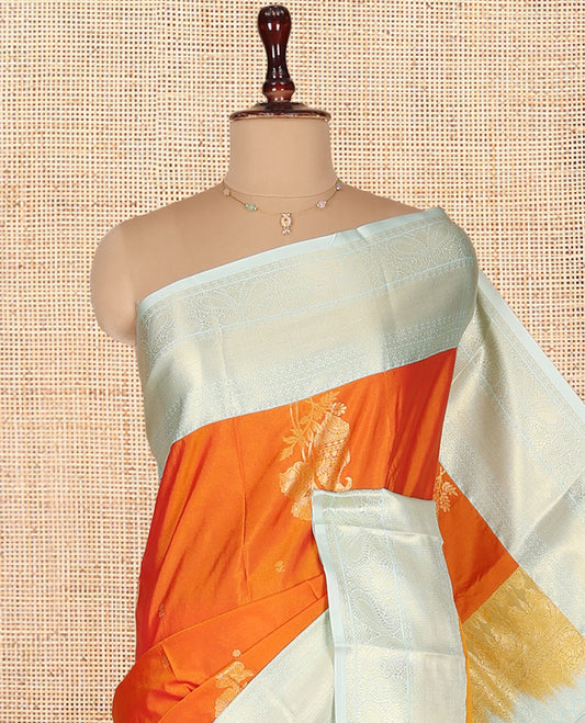 Orange Budget Silk Saree, Gracefully Embellished with Zari Buttas on Its Body, Complemented by a Contrast Traditional Zari Design Border, Intricately Designed Pallu, and Paired with a Contrast Blouse