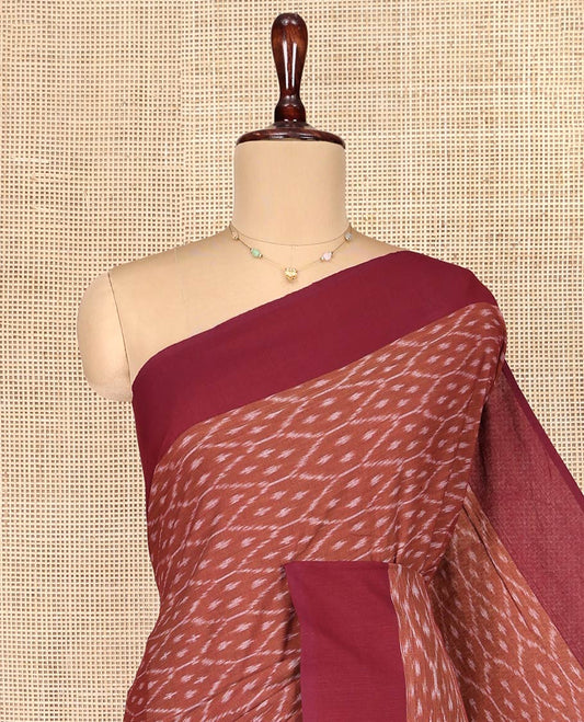 Brown Ikkat Cotton Saree, Steeped with Ikkat-Style Ogee Patterns on Its Body, Complemented by Contrast Border, Pallu Steeped with Ikkat Buttas, and Has No Blouse