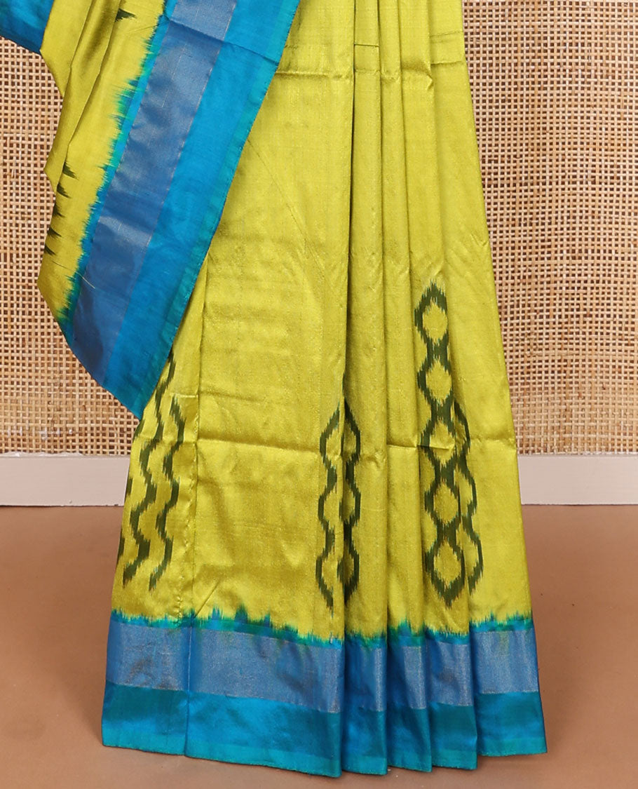 Green ikkat saree with ikkat buttas, contrast plain border & pallu of jaal design in ikkat weave