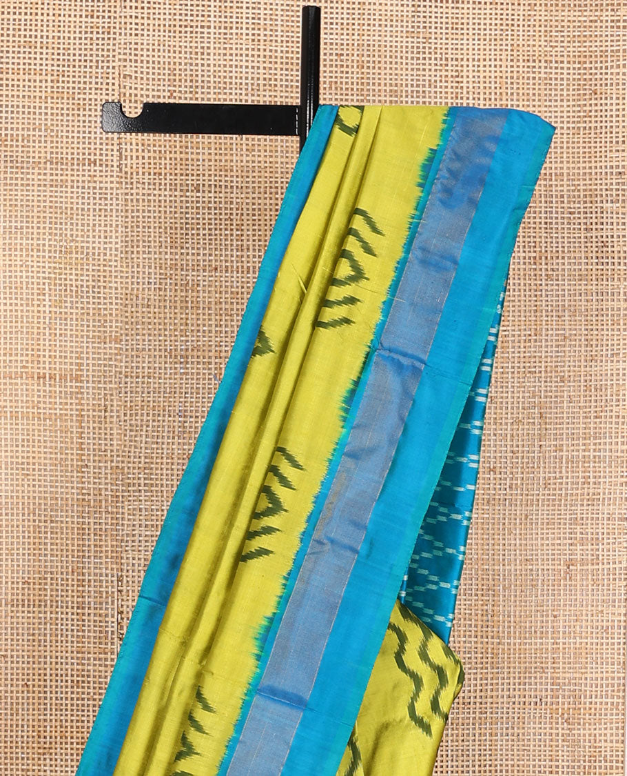 Green ikkat saree with ikkat buttas, contrast plain border & pallu of jaal design in ikkat weave