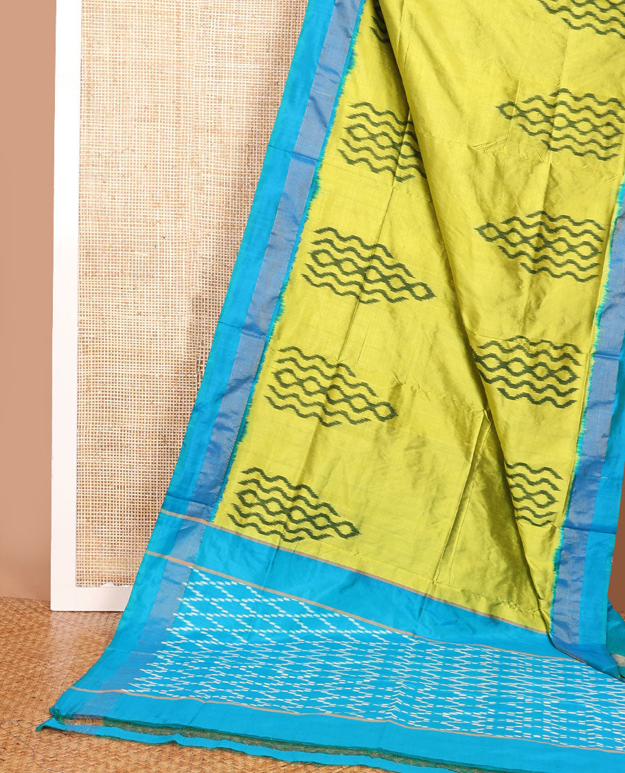 Green ikkat saree with ikkat buttas, contrast plain border & pallu of jaal design in ikkat weave