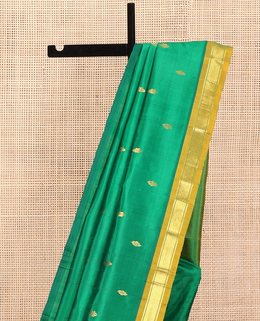 Green Kanchipuram Silk Saree, Decked Up with Zari Buttas, a Contrast One-Sided Border of Banaras and Muthu Design, Zari Design Pallu, and No Blouse