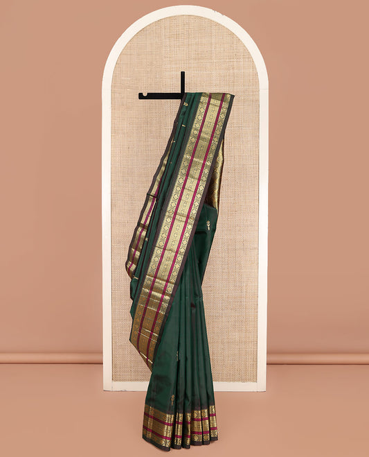 Green Kanchipuram Silk Saree, Mesmerized with Zari Buttas on Its Body, Complemented by a Contrast One-Sided Border of Rekku, Laddu Kamalam, Kathir, and Jada Nagam Designs, Pallu Steeped with Laddu Kamalam Designs, and Comes Without a Blouse