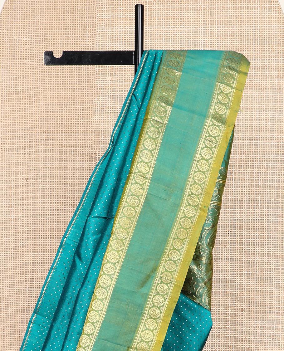 Green zari buttas Kanchipuram silk saree, contrast one-sided rettai pettu border of rekku and poo chakram, and zari design pallu