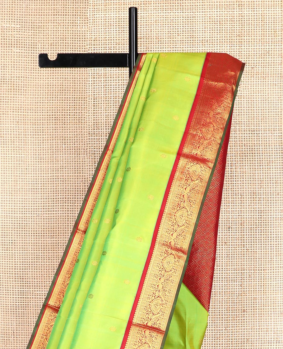 Green zari buttas Kanchipuram silk saree, contrast border of thilakam mokku, rettai neli, and mayil designs, and jaal design pallu