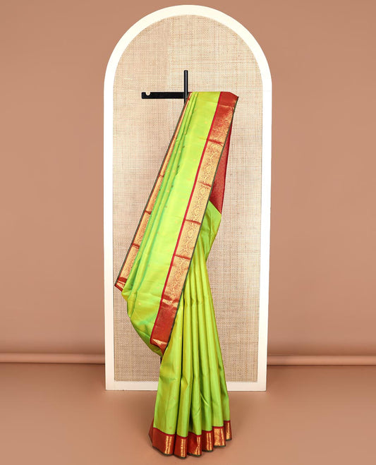 Green zari buttas Kanchipuram silk saree, contrast border of thilakam mokku, rettai neli, and mayil designs, and jaal design pallu