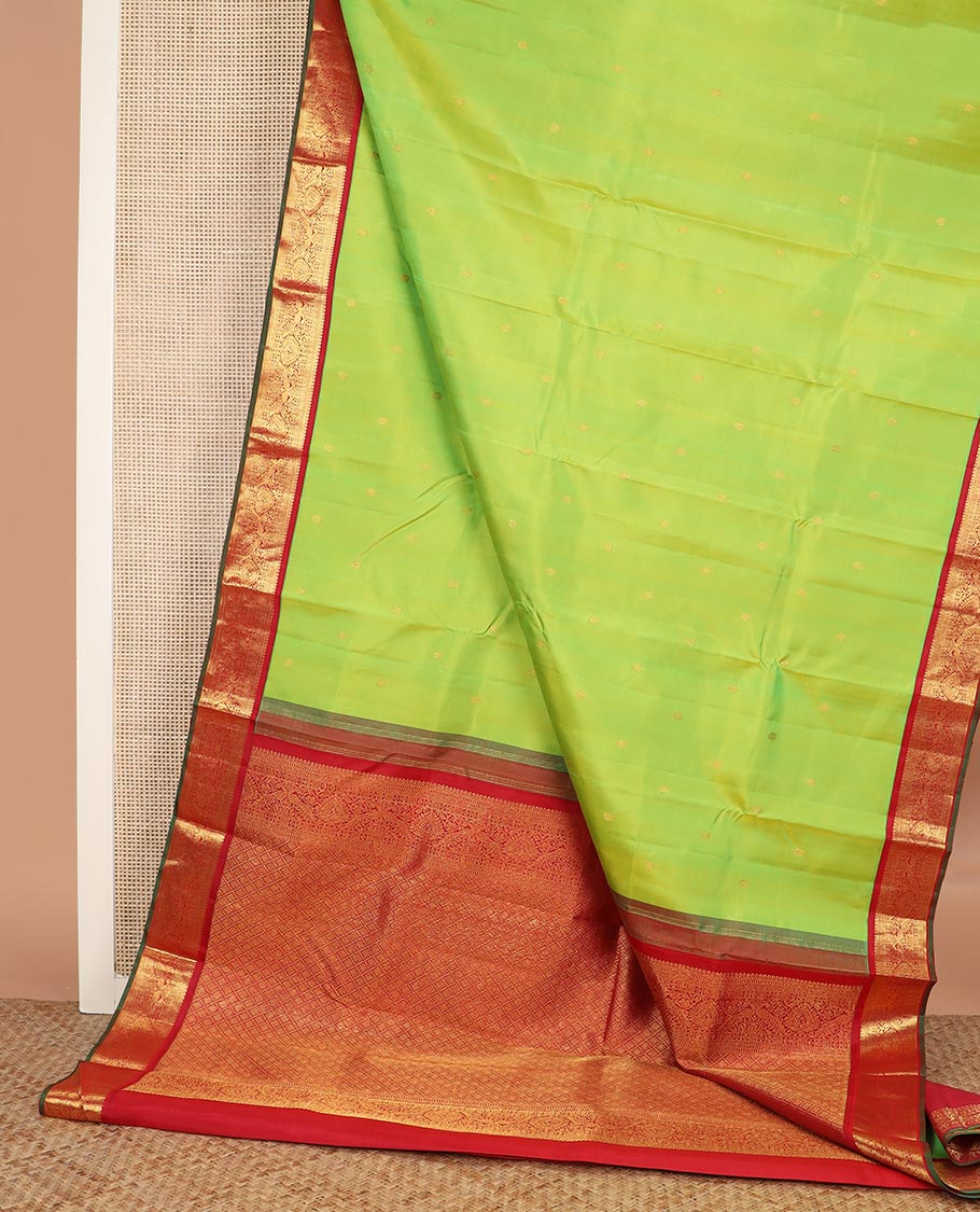 Green zari buttas Kanchipuram silk saree, contrast border of thilakam mokku, rettai neli, and mayil designs, and jaal design pallu