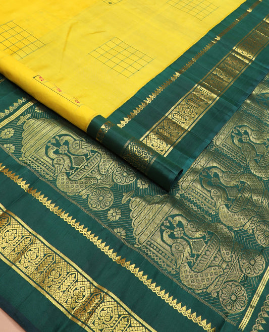 Yellow daayam kattam inspired motifs Kanchipuram silk saree, contrast korvai rettai pettu border of thilakam mokku, and manga designs, and pallu of mayil chariot designs