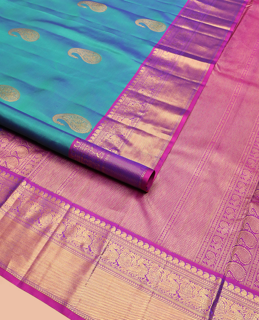 Blue arumbu manga buttas Kanchipuram silk saree, contrast border of manga mokku, muthu, kathir, and mayil designs, and vanki design pallu