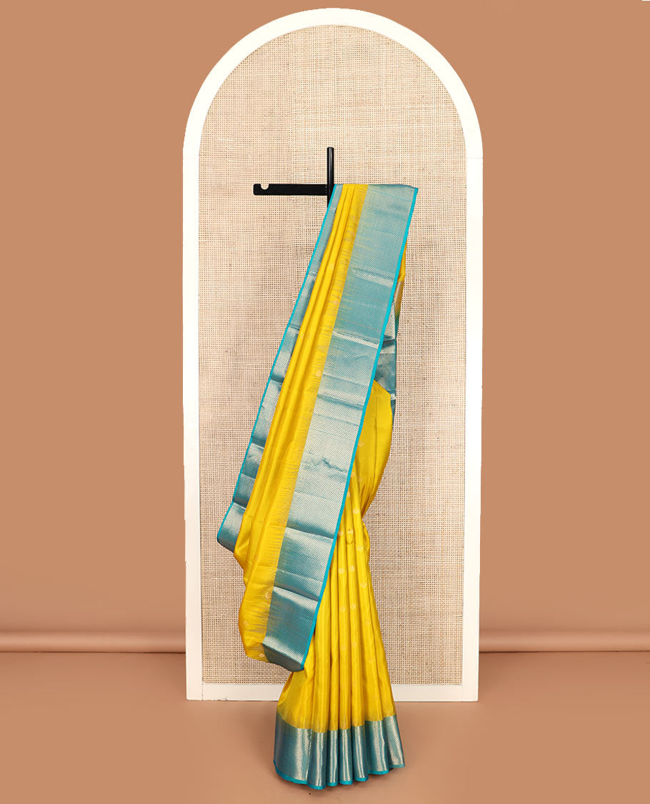 Yellow zari buttas Kanchipuram silk saree, contrast ara maadam design border, and pallu of ara maadam designs