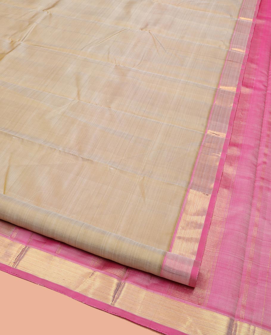 Light Sandal Plain Kanchipuram Silk Saree Subtly Sparkled with Contrast Zari Border, Pallu Features Zari Designs, and Paired with a Contrast Blouse