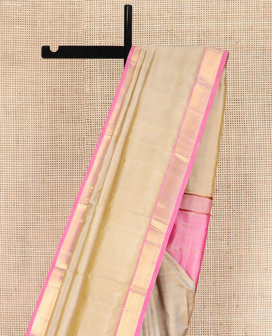 Light Sandal Plain Kanchipuram Silk Saree Subtly Sparkled with Contrast Zari Border, Pallu Features Zari Designs, and Paired with a Contrast Blouse