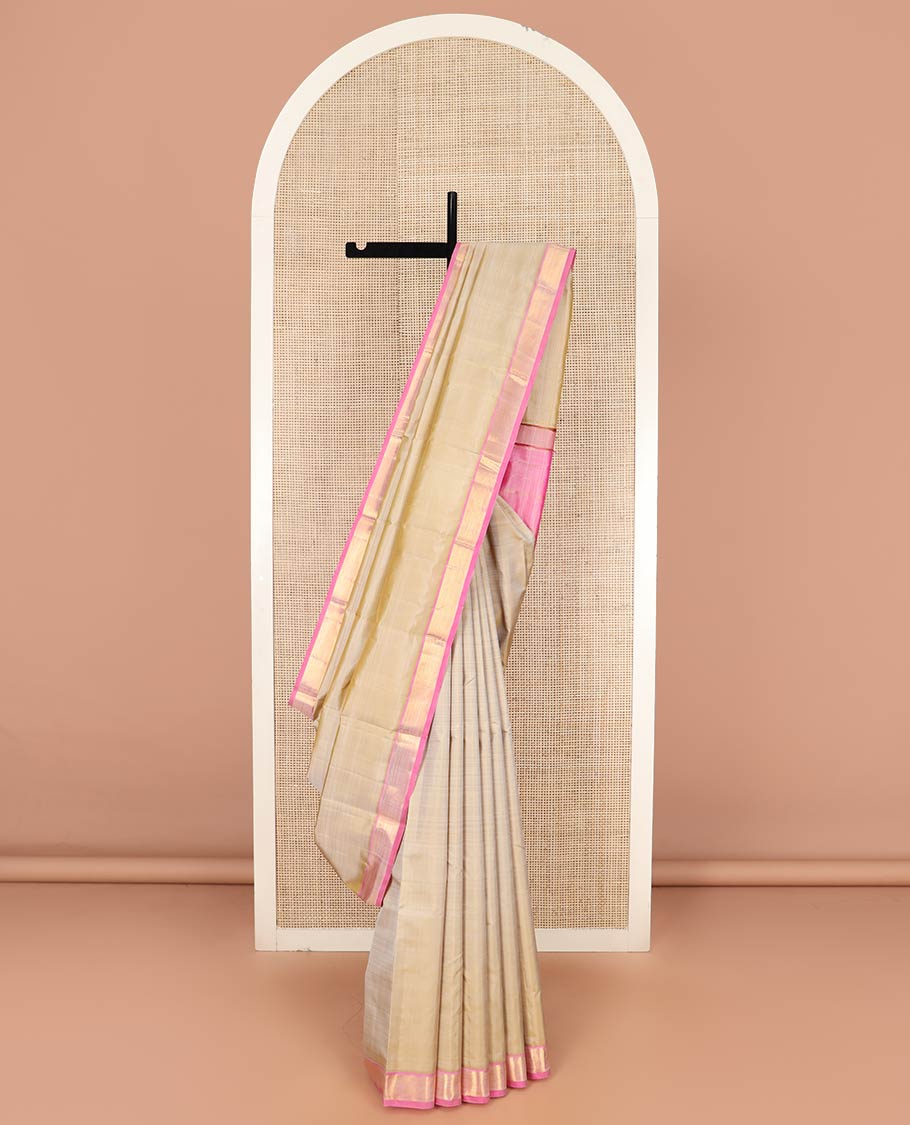 Light Sandal Plain Kanchipuram Silk Saree Subtly Sparkled with Contrast Zari Border, Pallu Features Zari Designs, and Paired with a Contrast Blouse