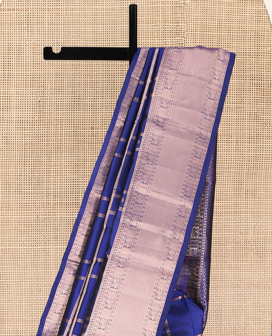 Blue Kanchipuram Silk Saree, Delicately Woven with Zari Buttas and Checked Design All Over Its Body, Highlighted by Zari Border of Manga Mokku, Paisa, Mayil, and Mayil Kann Designs, a Grand Jaal Pallu, and Paired with a Matching Blouse