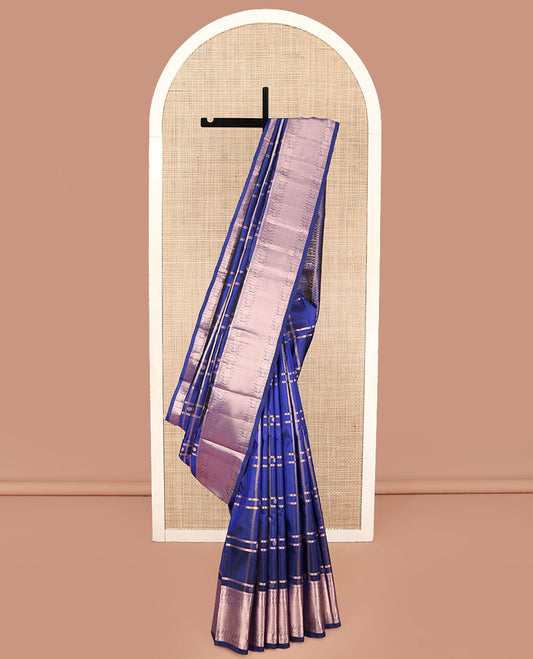 Blue Kanchipuram Silk Saree, Delicately Woven with Zari Buttas and Checked Design All Over Its Body, Highlighted by Zari Border of Manga Mokku, Paisa, Mayil, and Mayil Kann Designs, a Grand Jaal Pallu, and Paired with a Matching Blouse