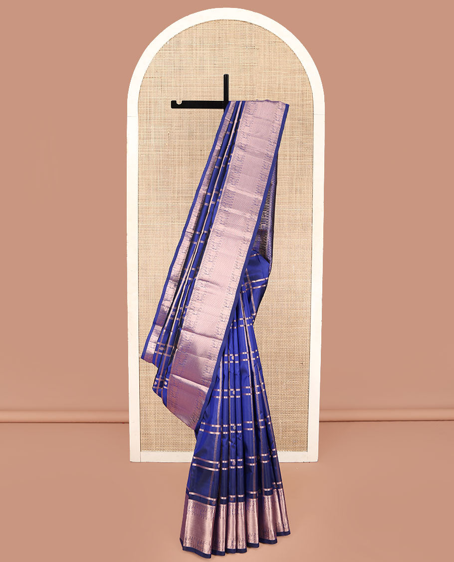 Blue Kanchipuram Silk Saree, Delicately Woven with Zari Buttas and Checked Design All Over Its Body, Highlighted by Zari Border of Manga Mokku, Paisa, Mayil, and Mayil Kann Designs, a Grand Jaal Pallu, and Paired with a Matching Blouse