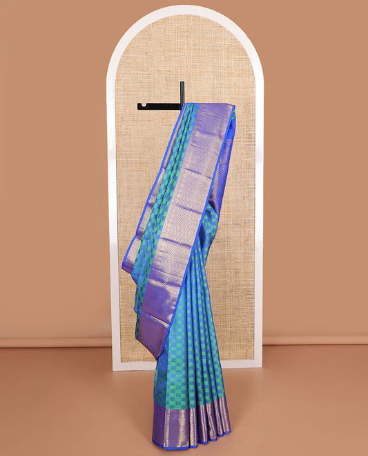 Blue checkered silk saree with contrast border of tilakam mokku, paun, mauil design & floral design pallu