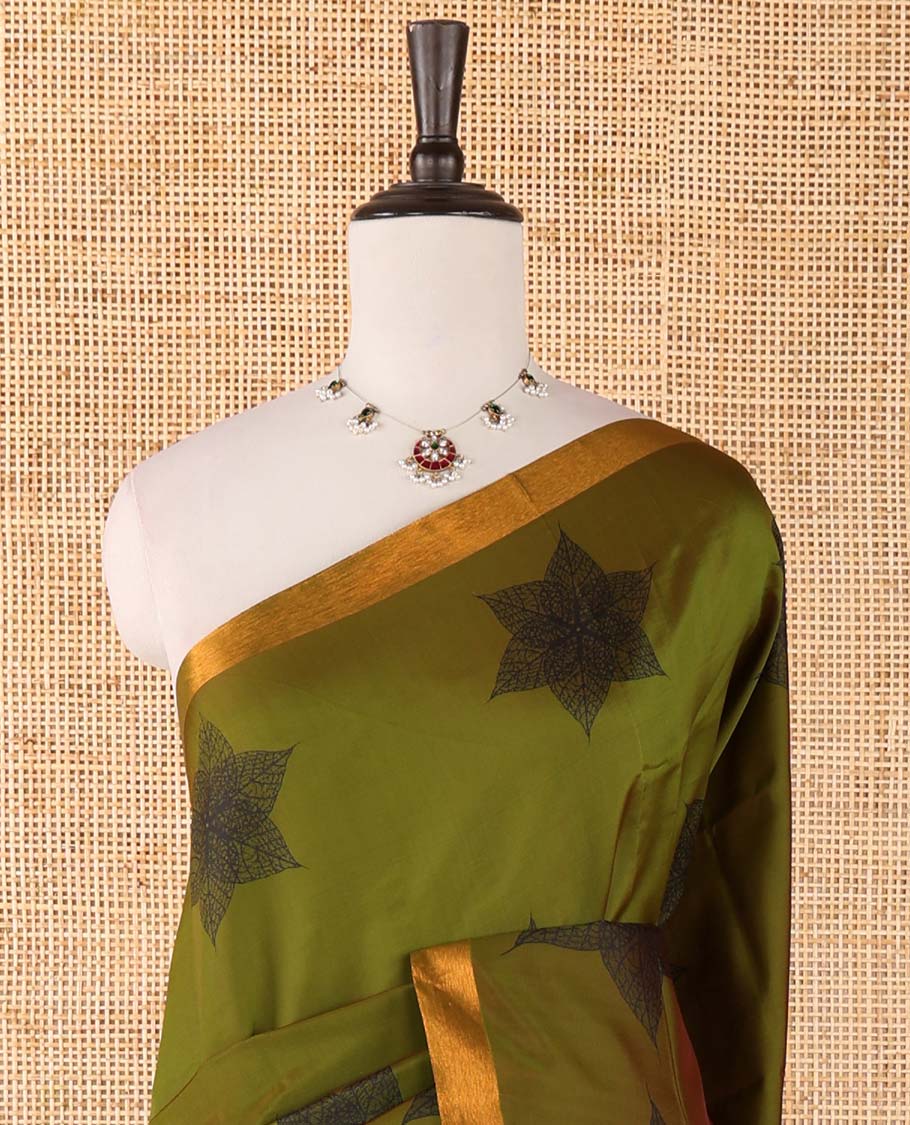 Olive green six-petal-like leaf motifs printed micro-silk saree, copper zari border, contrast intricate pallu & plain red blouse