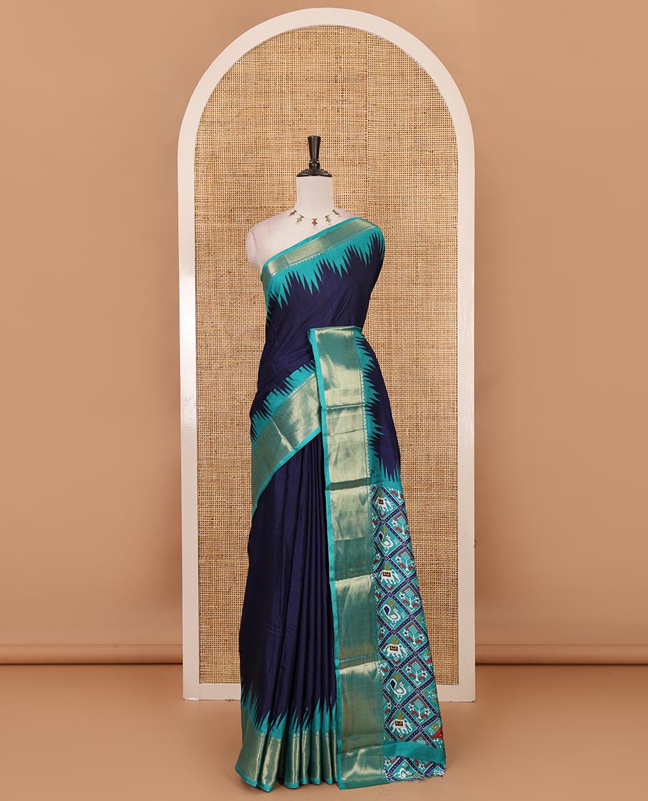 Navy blue plain dola-tussar saree, contrast temple zari border, patola animal motifs enclosed jaal printed pallu & patola printed blouse