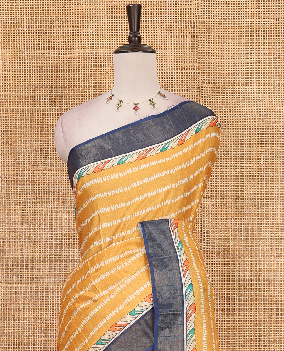 Mustard shibori-style printed soft-tussar saree, contrast zari border, kalamkari peacock printed pallu & kalamkari floral vine print contrast blouse