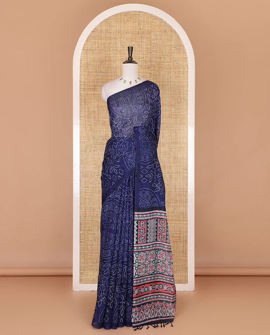 Borderless blue bandhani style floral, paisley, and chakra printed semi-jute silk saree, contrast ajrakh printed pallu, and ajrakh printed blouse