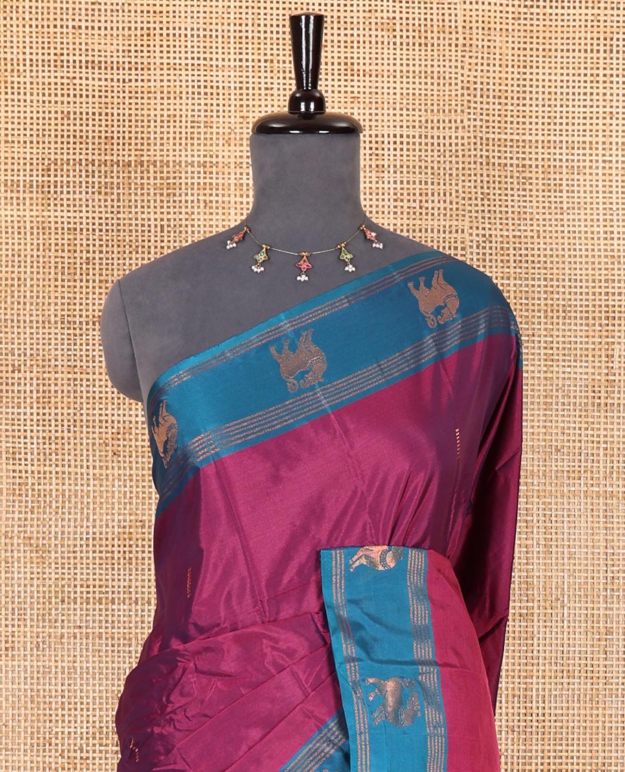 Magenta zari buttas Kanchi silk saree, contrast yaali motifs zari blue border, zari design pallu, and a matching blouse