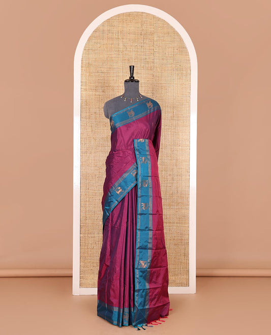 Magenta zari buttas Kanchi silk saree, contrast yaali motifs zari blue border, zari design pallu, and a matching blouse