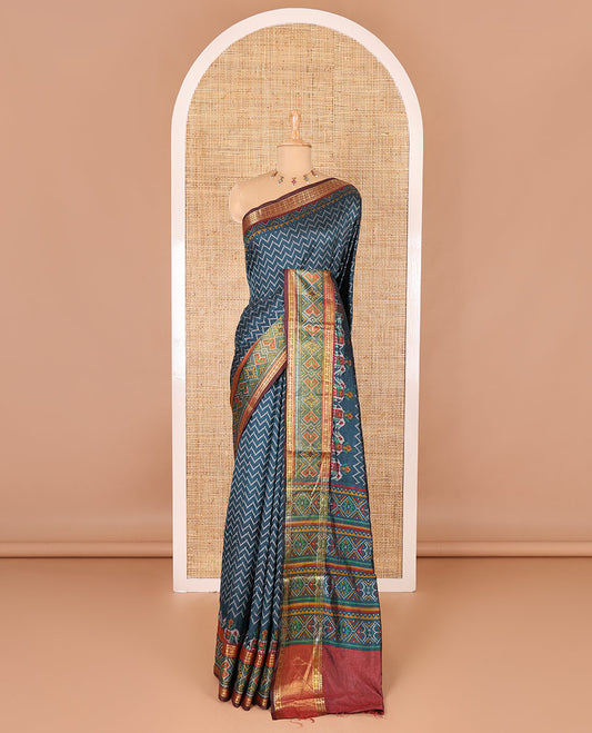 Green chevron striped patola saree, contrast traditional zari and patola printed border, patola printed pallu, and a contrast blouse