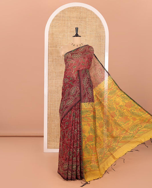 Maroon Khadi Cotton Saree Beautified with Kalamkari-Style Paisley-Floral Prints, Subtly Sparkled with Self-Border of Floral Creeper Designs, Complemented by Contrast Paisley-Floral Vine Pallu, and Paired with a Contrast Printed Blouse