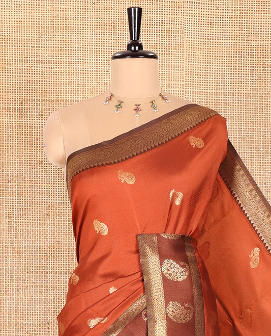 Rust Orange Kanchi Silk Saree, Accentuated with Paisley Zari Buttas All Over Its Body, Complemented by a Contrast Border of Floral and Paisley Designs, Grand Pallu of Jaal Design, and Paired with a Contrast Blouse