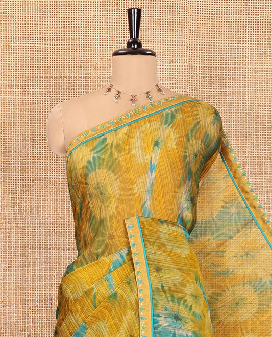 Mustard Chiffon Saree, Accentuated with Flower-Like Patterns Printed on Its Body, Subtle Lace Border, Pallu with the Same Print, and Paired with a Contrast Blouse