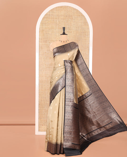 Chikku Kanchi Silk Saree, Adorned with Peacock-Chakram Buttas All Over Its Body, Complemented by a Contrast Border of Floral Creeper Designs, an Intricately Designed Pallu, and Paired with a Matching Blouse